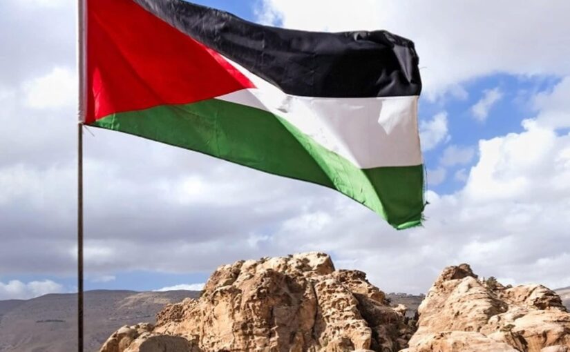 Flag of Palestine, flying over a rocky outcropping
