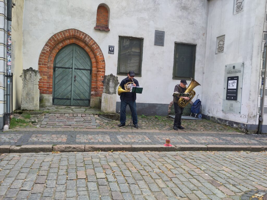 A french horn player and a tubist