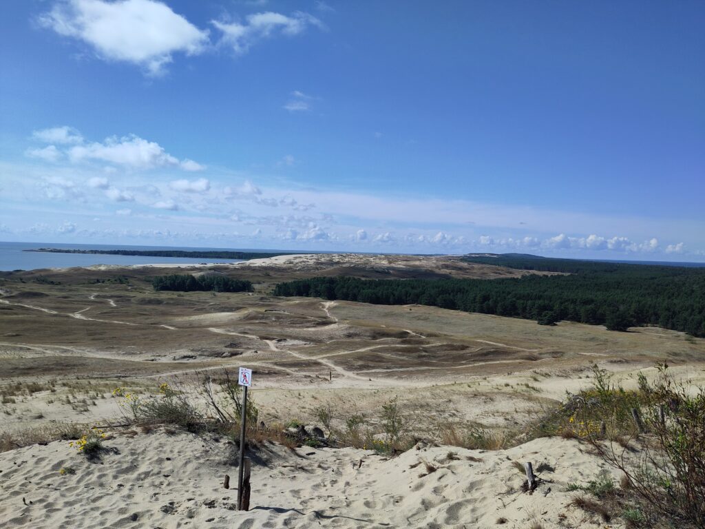Sand dunes, then woods, then more distant sand dunes, then Russia.